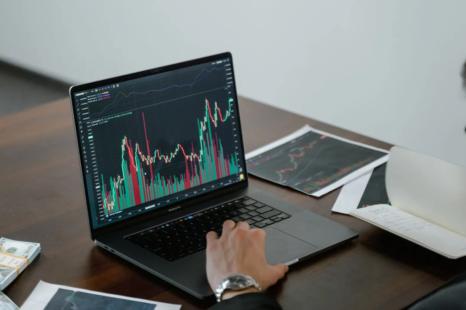 man tracking stock market on laptop